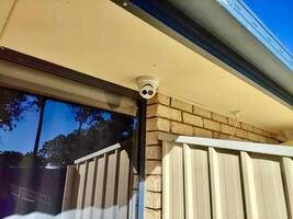 A camera is mounted on the side of a house photo