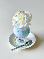 A dessert with a spoon and a cup of ice cream photo