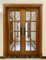A wooden double door with glass panels photo