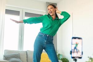 Professional Blogging. Joyful Blogger Woman Making Via Smartphone Having Fun Dancing And Posing At Home. Online Blog And Social Media Concept. Selective Focus photo