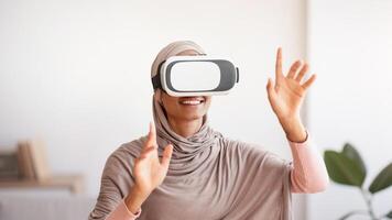 Black lady in traditional hijab using VR headset to interact with virtual reality at home. Muslim lady in headscarf exploring cyberspace indoors. Futuristic technologies concept photo