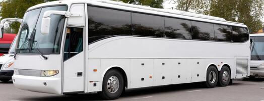 A white bus is parked in a parking lot photo