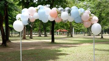 A balloon arch with pink and blue balloons photo