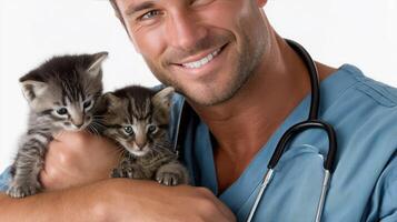 A man in a blue shirt holding two kittens photo