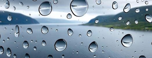 Raindrops on a window with a lake in the background photo