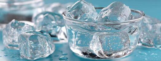 Ice cubes in a glass with water on a blue background photo