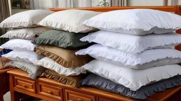 A pile of pillows with ruffles on top of a dresser photo