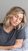 A woman sleeping in bed with her eyes closed photo