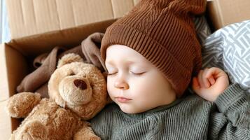 A young child sleeping with a teddy bear photo