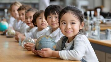 Children in school classroom holding globe photo