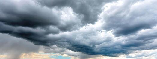 A large storm cloud is seen over a field photo