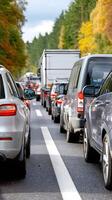 Many cars are driving on a busy road photo