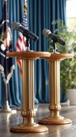 Microphones on podiums in front of a blue curtain photo
