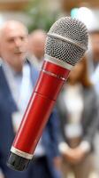 A microphone is in front of a group of people photo