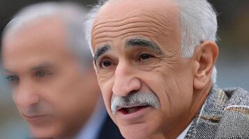 Two older men with white hair and moustaches photo