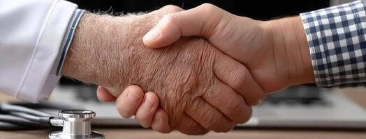 A doctor shaking hands with an elderly person photo