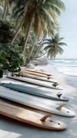 Surfboards lined up on the beach near the ocean photo