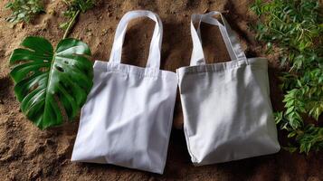 Two white tote bags on a dirt background photo