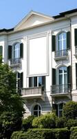 A large white building with green shutters photo
