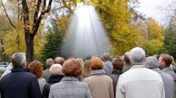 A group of people standing in front of a tree with a beam of light coming from it photo