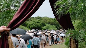 A person holding an umbrella in front of a crowd photo