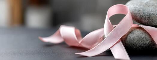 Pink ribbon on rocks photo