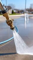 A pressure washer spraying water onto a concrete surface photo