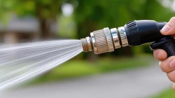 A person is holding a hose with water coming out photo