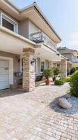 A driveway with a garage and a patio area photo