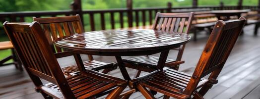 Wooden table and chairs on a wooden deck photo