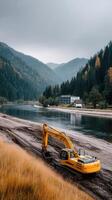 A yellow excavator is parked on the side of a river photo