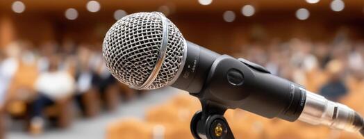 Microphone on stage in front of a crowd of people photo