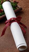 A roll of white paper with a red ribbon tied around it photo