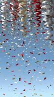 A bunch of confetti falling from the sky photo
