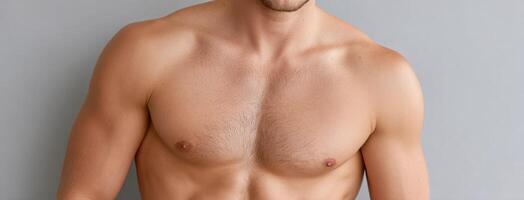 A man with no shirt on is posing photo