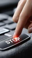 A person pressing a button on a car with the word stop photo