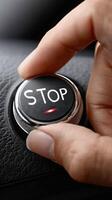 A person is pressing a stop button on a car photo