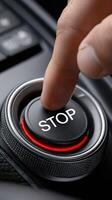 A person pressing a stop button on a car photo