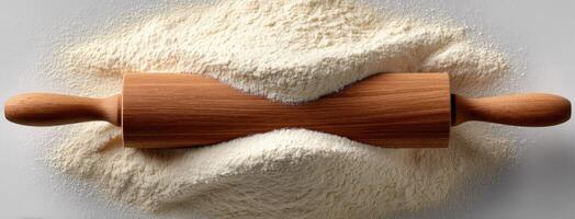 A rolling pin and flour on a white background photo
