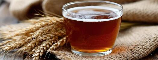 A glass of beer and some wheat on a table photo