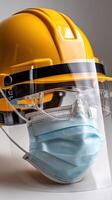 A yellow construction helmet with a face mask photo