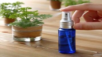 A person is holding a spray bottle with a plant in it photo