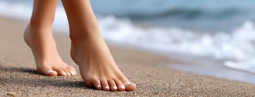 A woman's feet on the beach with sand photo