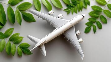 A model airplane is surrounded by green leaves photo