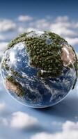 A globe with trees and clouds in the sky photo