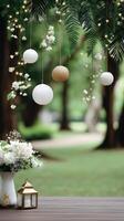 A table with white flowers and hanging lanterns photo