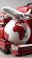 A red suitcase, a red bus and an airplane on top of a globe photo