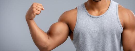 A man flexing his muscles on a gray background photo