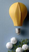A yellow light bulb with white paper flowers photo