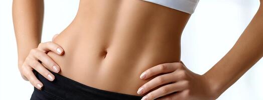 A woman's stomach with her hands on her hips photo